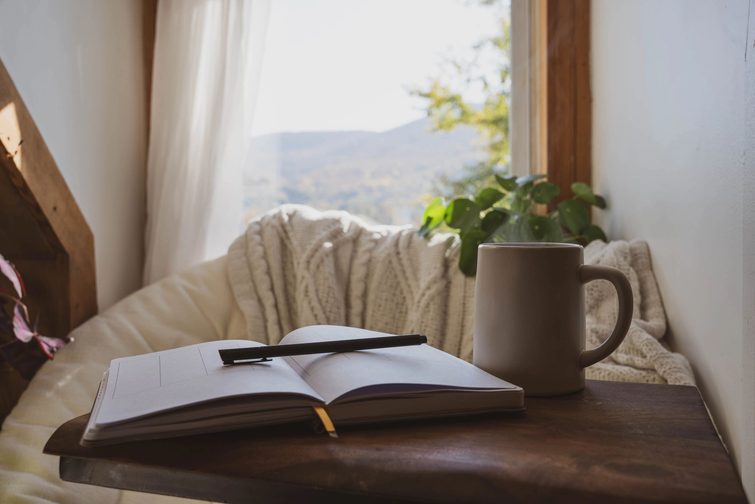 Open journal and coffee in a cozy setting