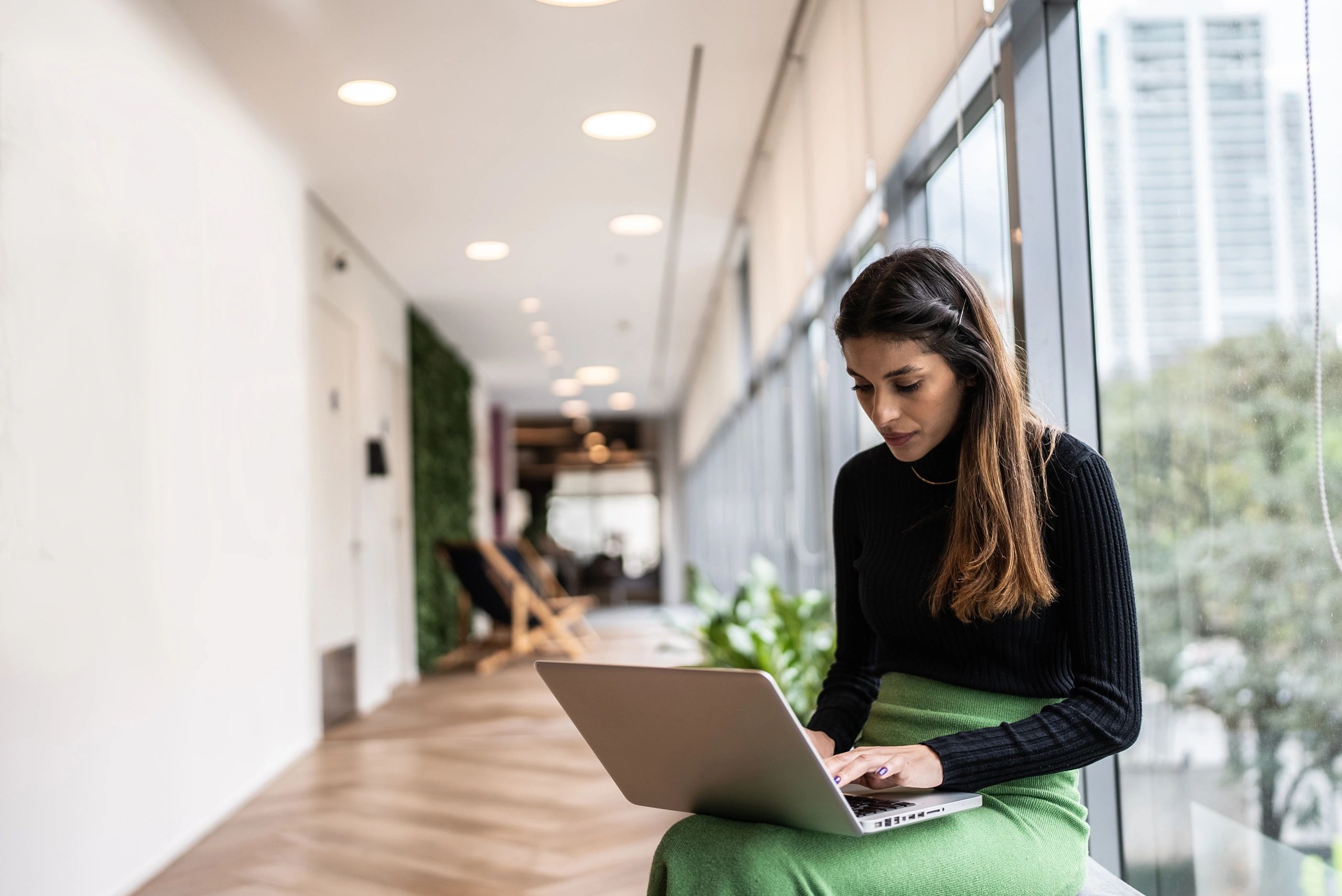 Person planning on a laptop at a desk