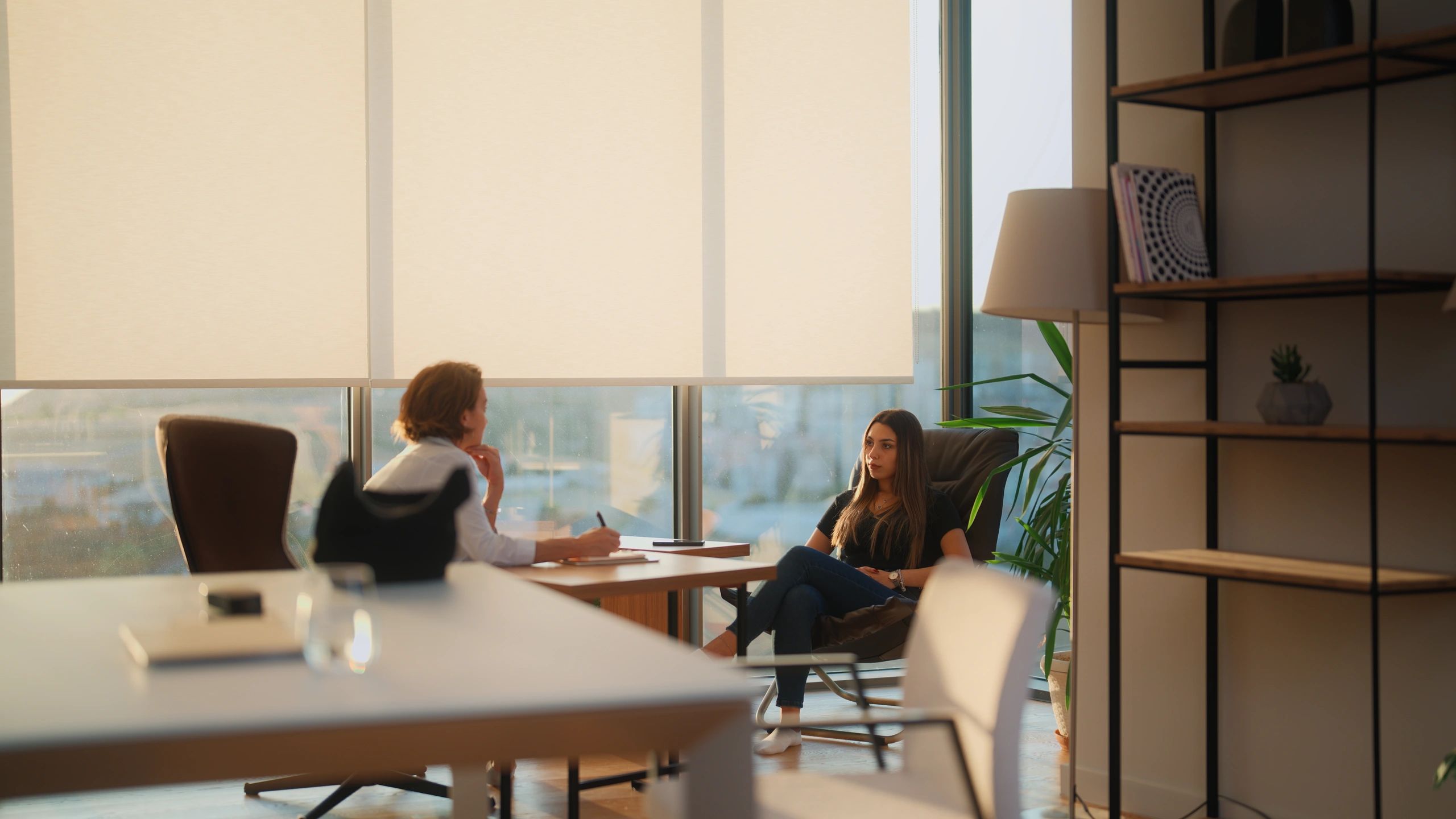 Client speaking with a mental health professional in a warm office