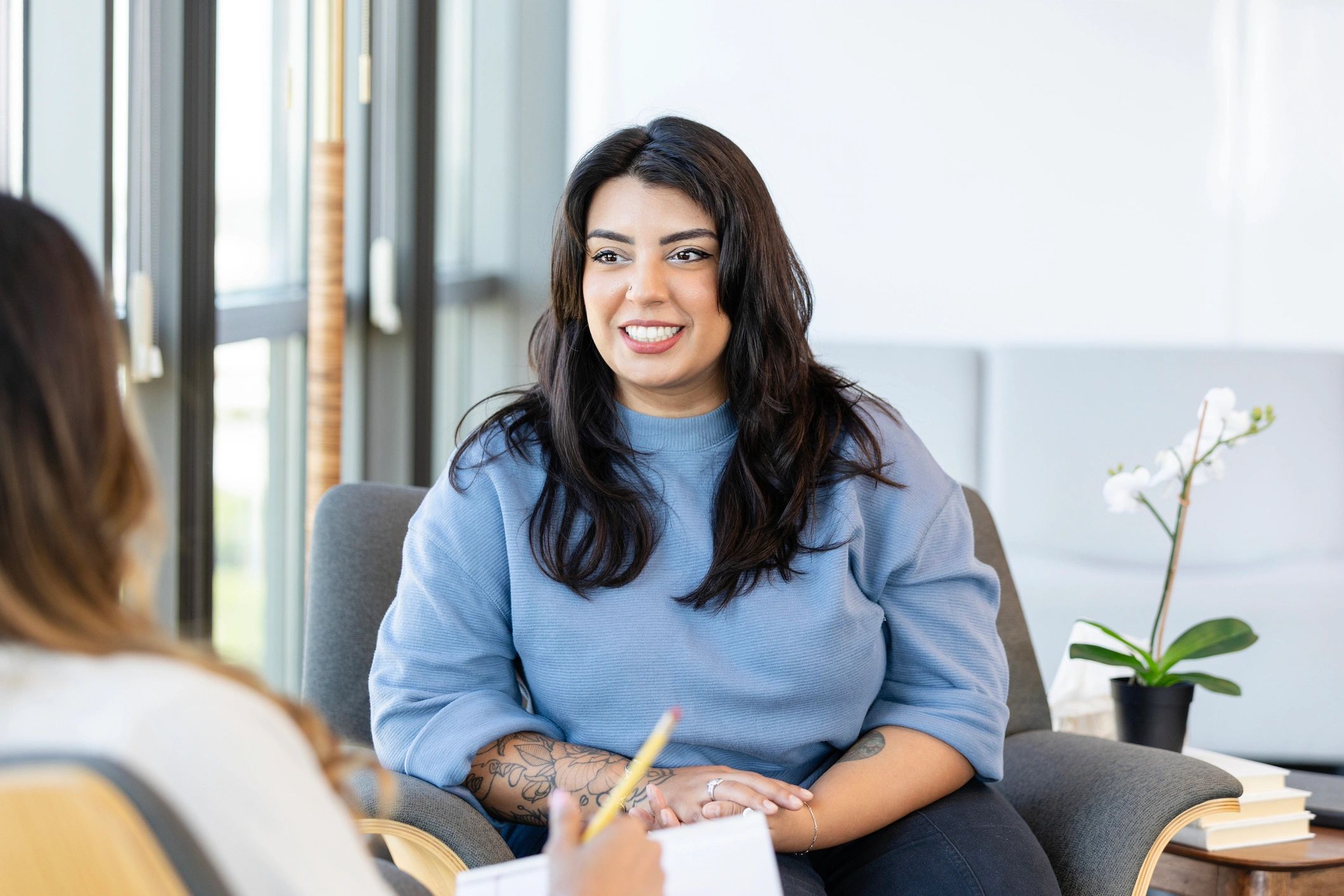 Client and counselor in a warm, supportive office setting